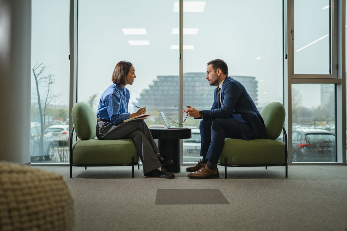 Two professionals in a focused consulting meeting